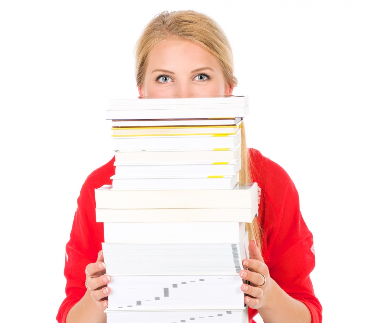 Student holding a tall stack of books for Purpose Tutoring article about college admissions